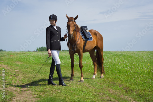 Beautiful young girl jockey with her horse