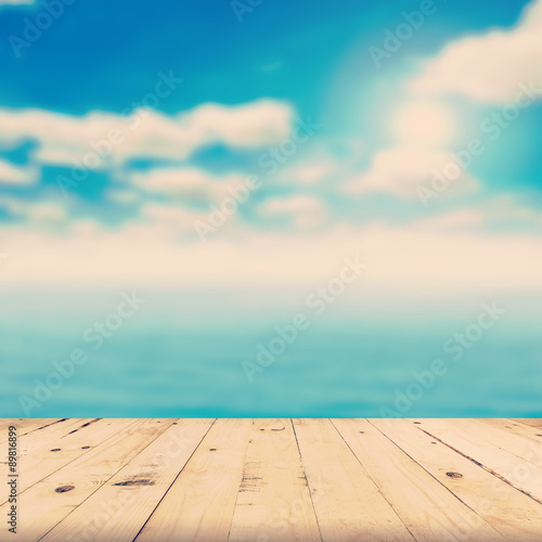 wood tabletop and blurred sea with vintage tone