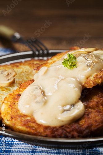 Homemade potato pancakes served with mushroom sauce and mushroom