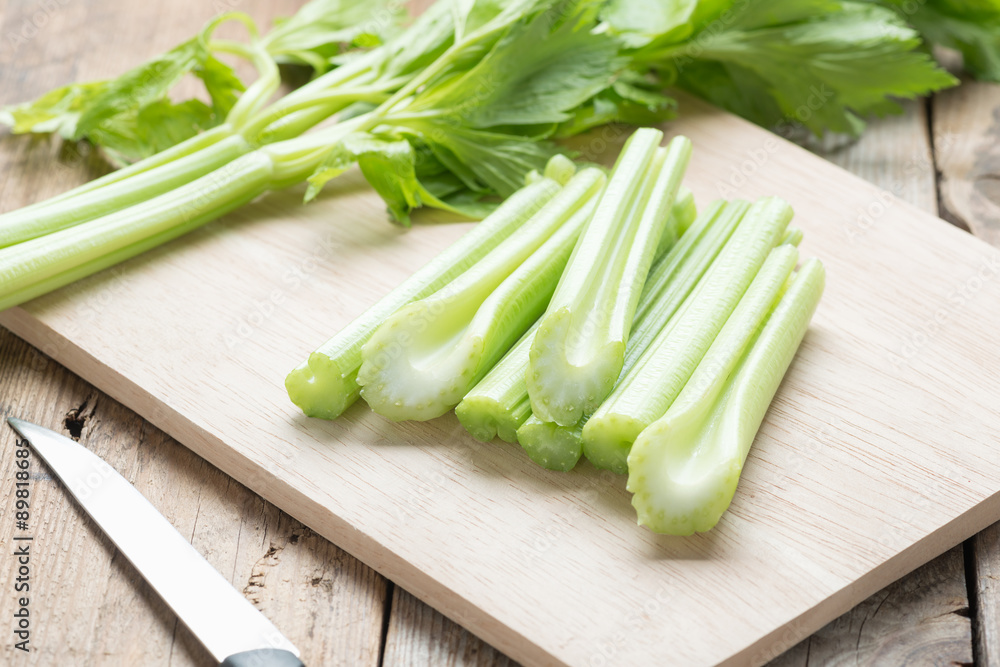 Fresh celery chopped on wooden cutting board. Fresh celery chopped on wooden cutting board.