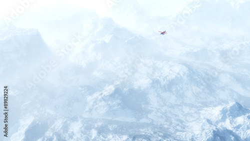 Fototapeta Naklejka Na Ścianę i Meble -  Small red airplane flying over snow mountains in the mist. High