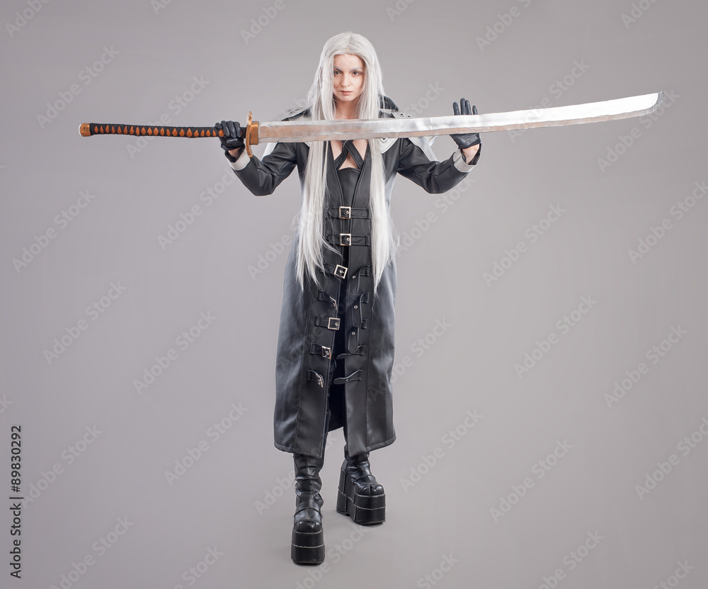 Fantasy woman warrior / Woman warrior with sword and armor isolated on the gray background Fantasy woman warrior / Woman warrior with sword and armor isolated on the gray background