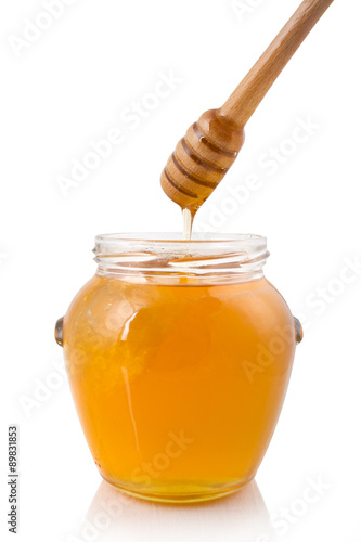 Honey dripping into a jar

