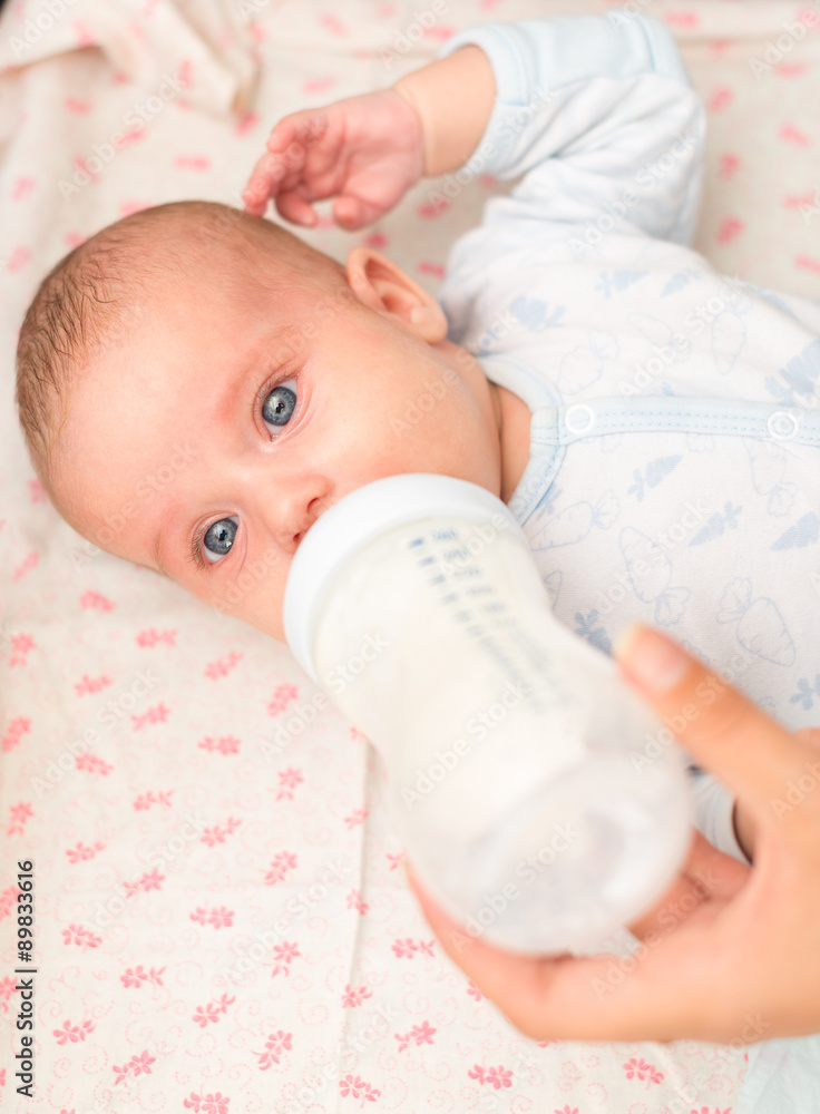Mother feeding newborn baby from the bottle. Mother feeding newborn baby from the bottle.