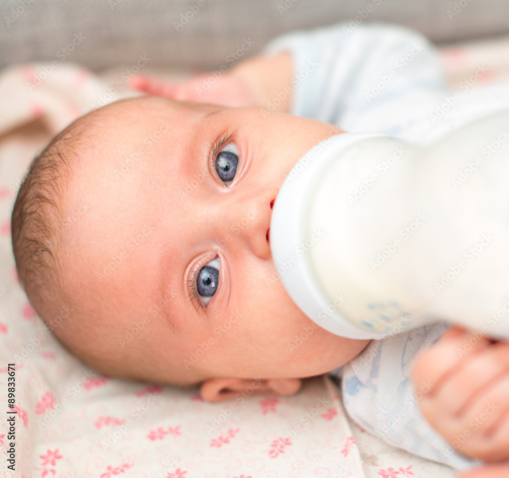 Mother feeding newborn baby from the bottle. Mother feeding newborn baby from the bottle.