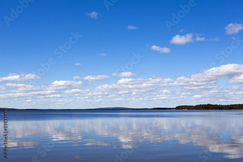 A beautiful scene in Finland in the summer time. Some clouds in the sky giving a deep contrast to the image. © Jne Valokuvaus