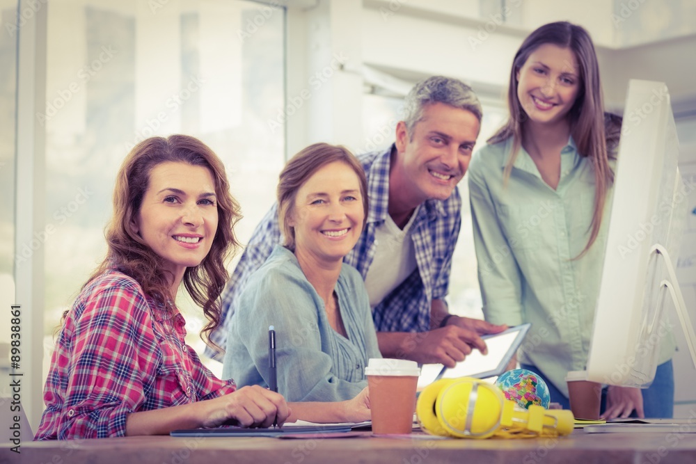 Casual business team having a meeting using a computer Casual business team having a meeting using a computer