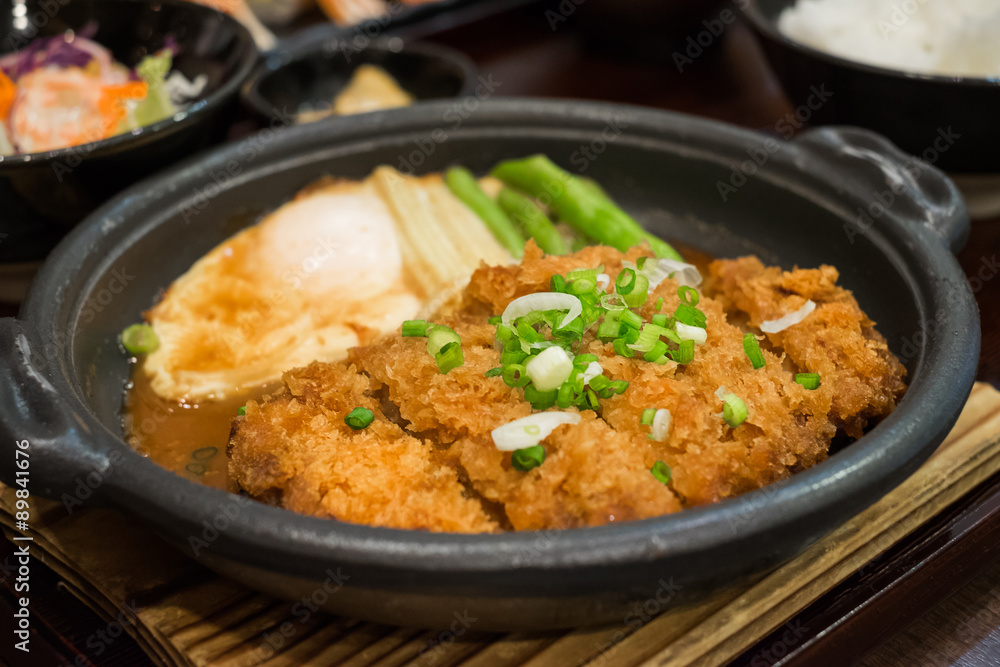 Cutlet pork simmered in miso sauce with fried egg on hot plate