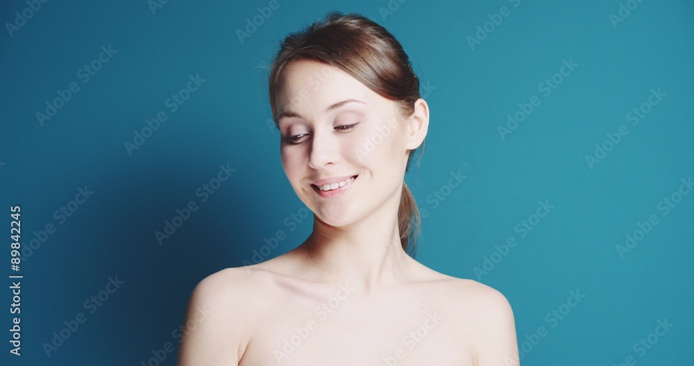 Closeup portrait of Beautiful healthy smiling woman with fresh skin. Slow Motion. Skincare concept. Young woman with glowing skin and bright eyes, beauty portrait on a blue keying background. Closeup portrait of Beautiful healthy smiling woman with fresh skin. Slow Motion. Skincare concept. Young woman with glowing skin and bright eyes, beauty portrait on a blue keying background.