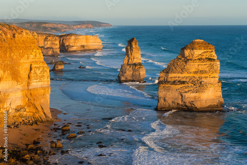 The yellow glow of the landmark Twelve Apostles along the famous Great Ocean Road, Victoria, Australia at sunset