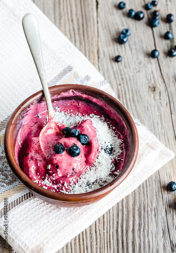 banana ice cream with blueberries and coconut flakes