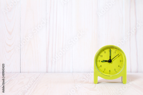 Wallpaper Mural Green alarm clock on wood background Torontodigital.ca