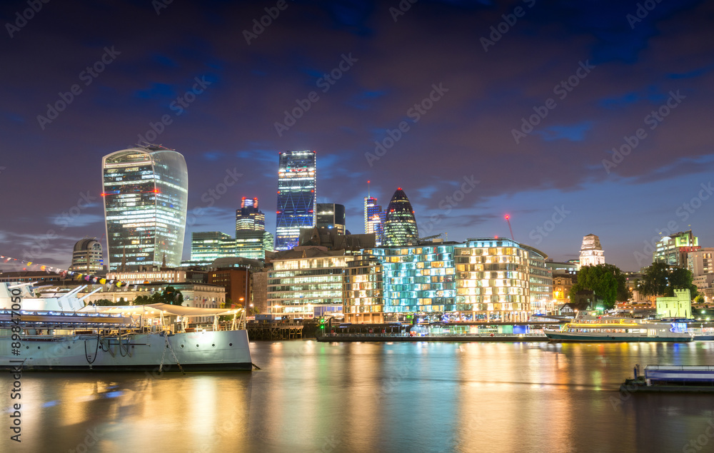 Night lights of London. Buildings reflections near river Thames