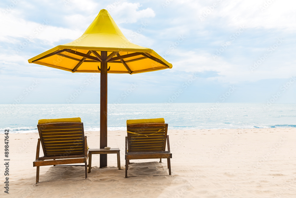 Beach chairs with umbrella and sand beach