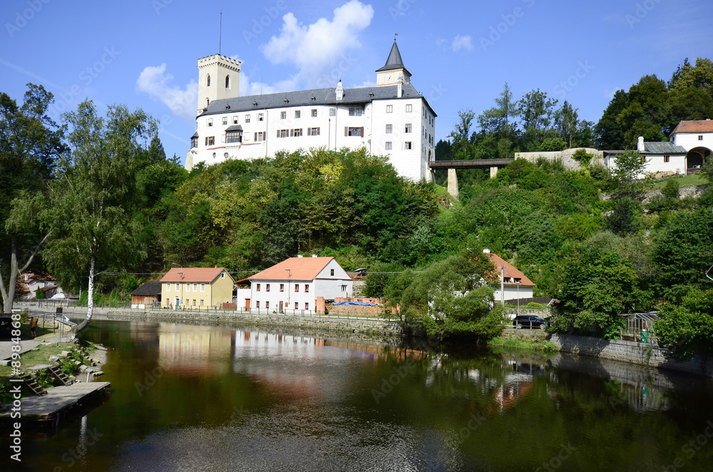 Czech Republic, village Rozmberk nad Vltavou with castle and reflection in Moldau river