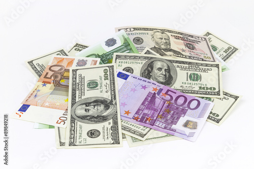 Heap of different currencies isolated on white background