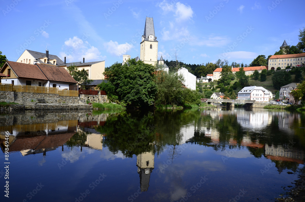 Czech Republic, village Rozmberk nad Vltavou with castle and reflection in Moldau river