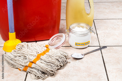 Foto Baking soda with pail, mop, detergent for house cleaning.