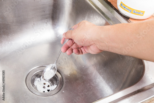 Tableau sur toile Baking soda poured to unclog drainage system at home.