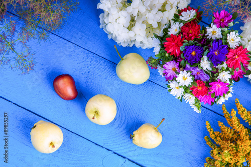 Flowers and fruits on a blue wooden table