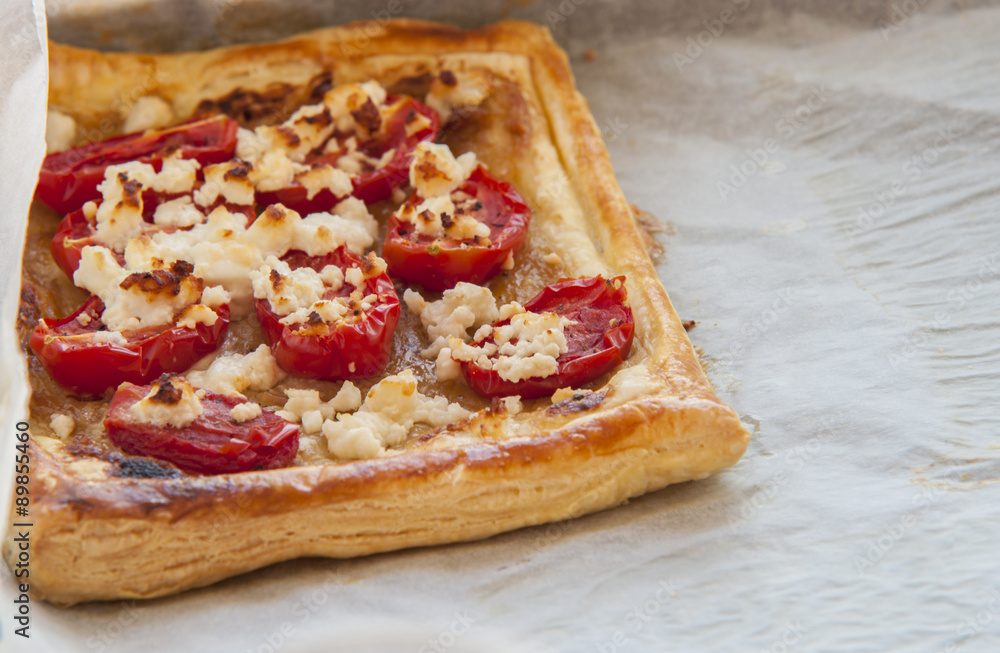 Tomato tart, puff pastry topped with mustard, cheese and cherry toamtoes. Tomato tart, puff pastry topped with mustard, cheese and cherry toamtoes.