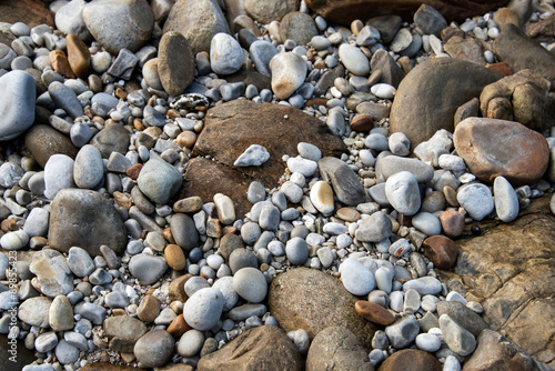 A close up of rocks and pebbles on a beach