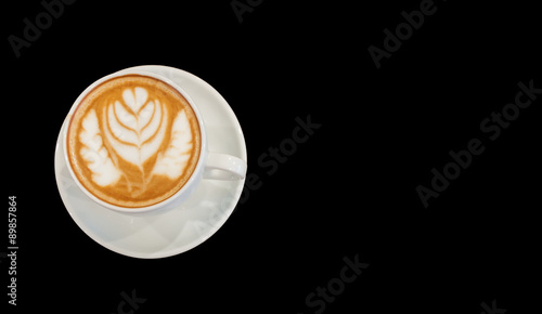 Hot cafe latte wirh latte art on black background