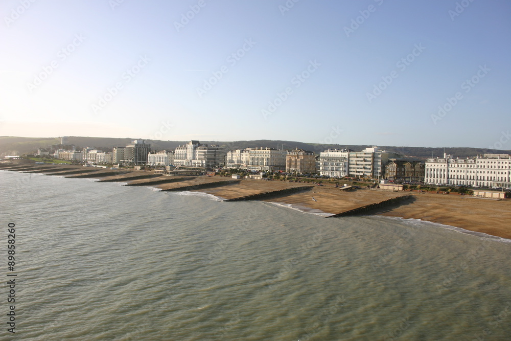 View of sea, beach and tall buildings