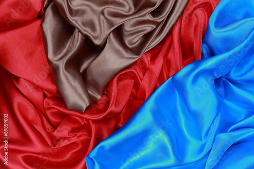 Blue and brown and red silk satin cloth of wavy folds texture ba