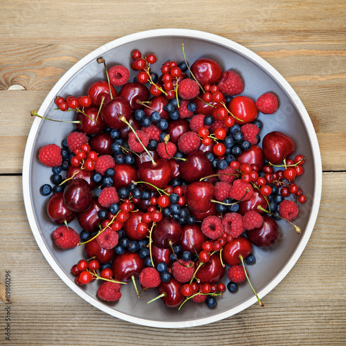  Fresh wild berries: raspberries, blueberries, currants and cherries. Top view 

