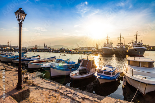 fishing boats in port of Sozopol at sunset photo