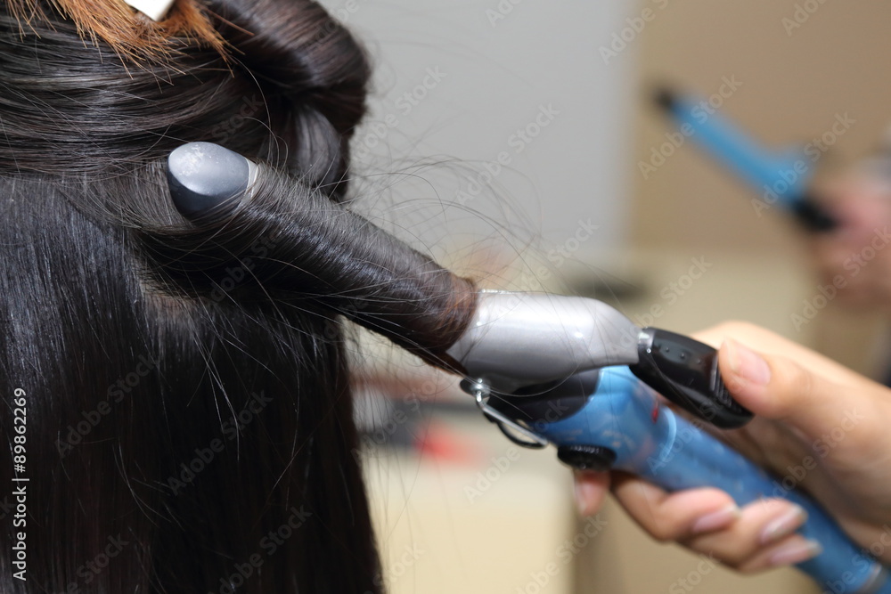 Fototapeta premium close up on asian woman curling her hai