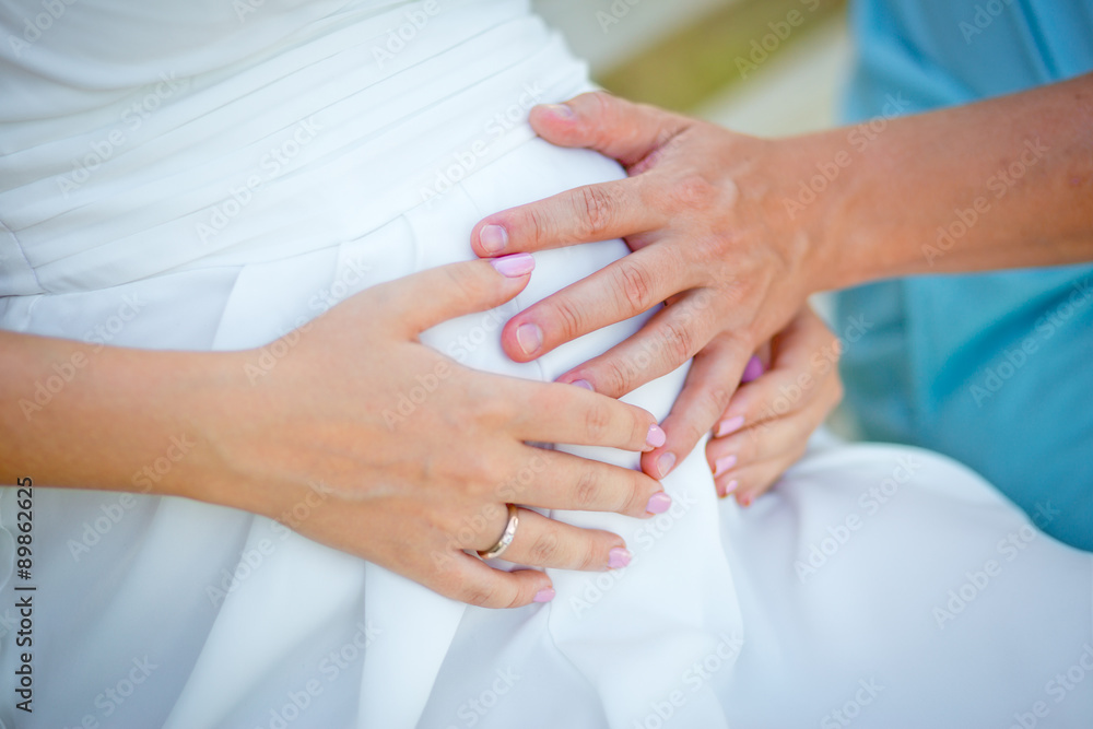 Hands of future father and future mother on a stomach of the pre Hands of future father and future mother on a stomach of the pre