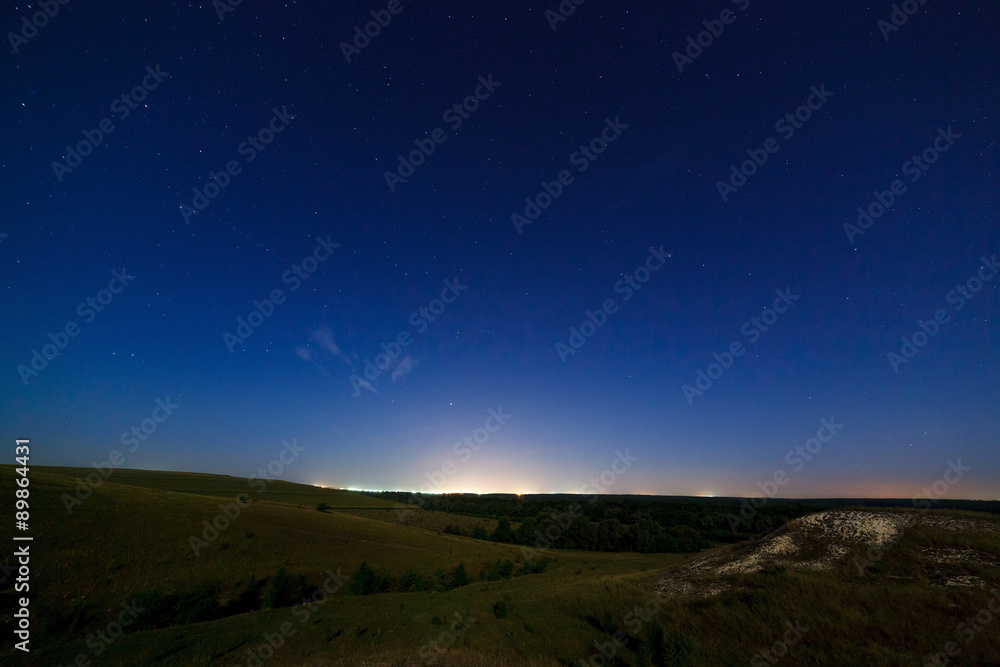 The starry sky above the lighted lanterns city. The starry sky above the lighted lanterns city.