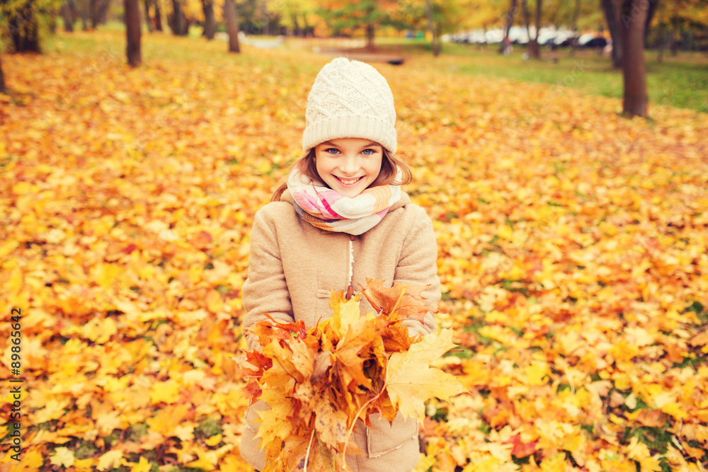 smiling little girl with autumn leaves in park smiling little girl with autumn leaves in park
