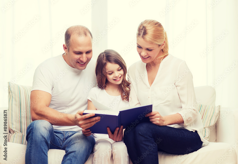 smiling parents and little girl with at home