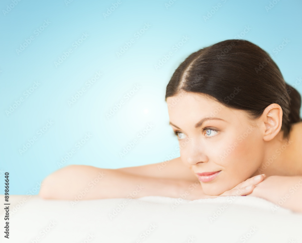 happy beautiful woman lying on massage desk at spa happy beautiful woman lying on massage desk at spa