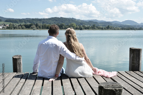 A couple on the wooden jetty at the lake. Switzerland © HappyAlex