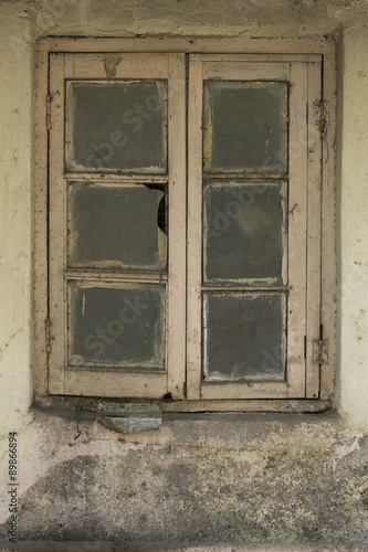 Old cracked wall with a window