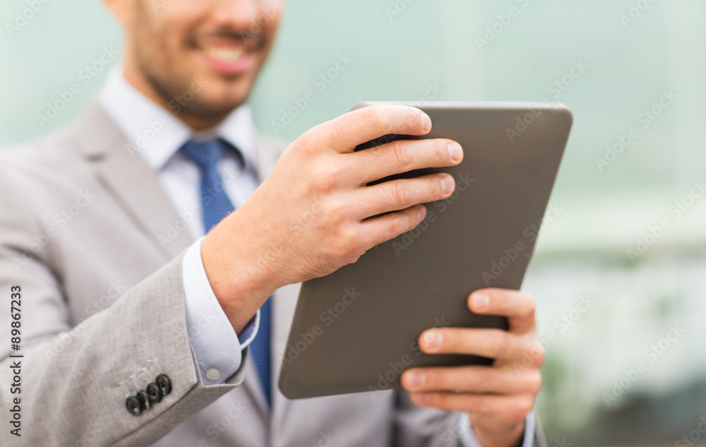 close up of business man with tablet pc in city close up of business man with tablet pc in city