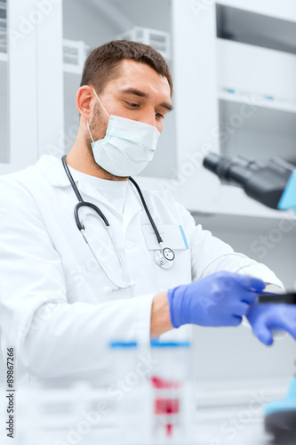 young male scientist wearing gloves in lab