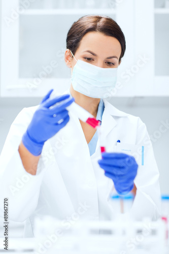 close up of scientist holding test tube in lab