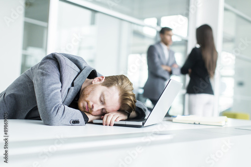 Tired young man sleeping in...