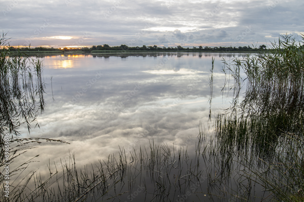 sunrise reflecting over calm lake sunrise reflecting over calm lake