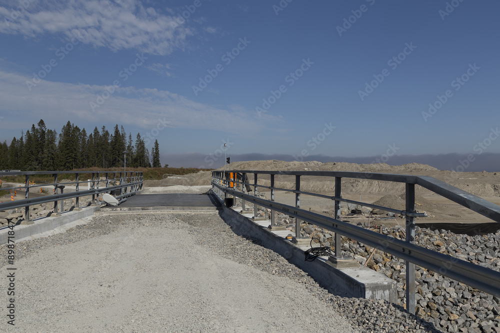 Fototapeta premium A bridge that is under construction with a sky and some trees in the background