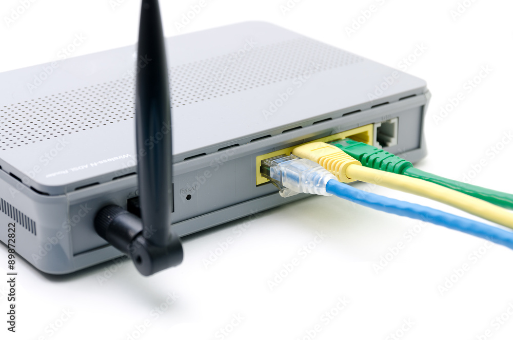 Closeup of network cables connected to wifi router on white