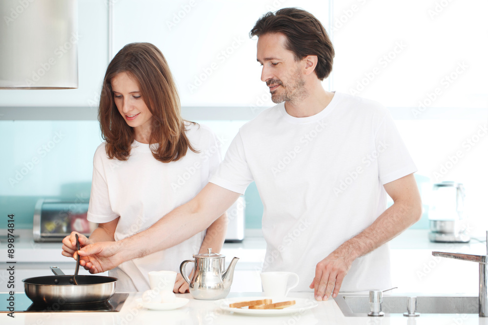 couple cooking breakfast