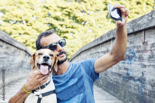 young man takes a selfie with his dog
