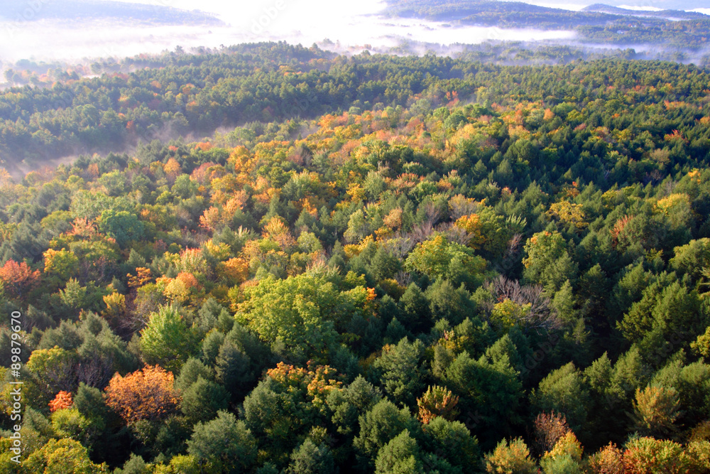 An aerial view of a hot air balloon floating over the Vermont country side .. An aerial view of a hot air balloon floating over the Vermont country side ..