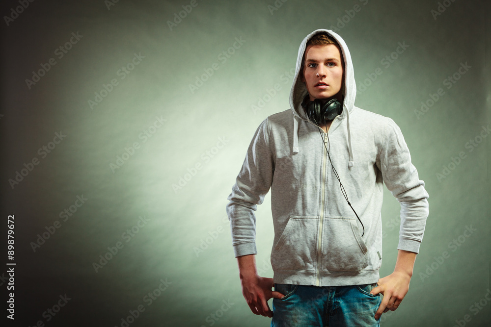 Hooded man with big headphones on neck